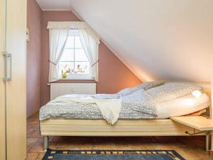 a bedroom with a bed and a window at Birkenstraße 7 Whg 6 in Zingst