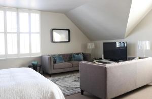 a living room with a couch and a television at Briarwood in Greytown