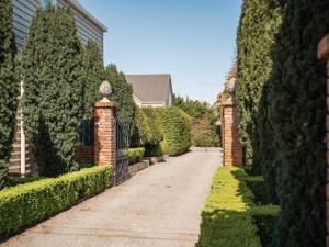 a driveway leading to a house with hedges at Briarwood in Greytown