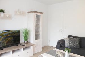 Televízia a/alebo spoločenská miestnosť v ubytovaní Appartement Steffens - "Brookgang - Nr 2"