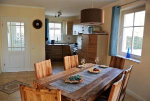 a kitchen and dining room with a wooden table and chairs at Wiesenstraße 40 in Zingst