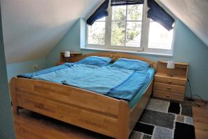 a bedroom with a bed with a wooden frame and a window at Wiesenstraße 40 in Zingst