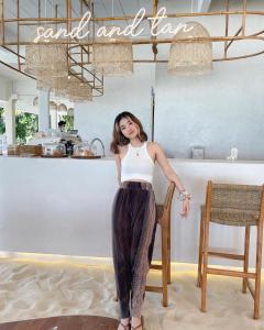 a woman in a dress standing in a room at Phangan Bayshore Resort Koh Phangan - SHA Plus in Haad Rin