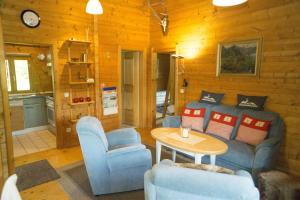 a living room with a couch and a table at Blockhaus Bayerischer Wald in Stamsried