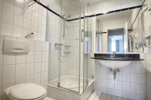 a bathroom with a toilet and a sink and a shower at Am Kurhaus 211 PP 66 in Zingst