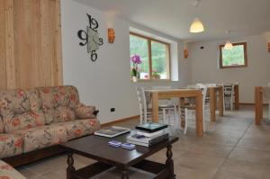 a living room with a couch and a table at Garnì dal Mozat in Ledro