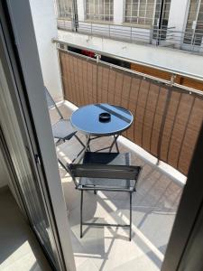 a table and a chair on a balcony at Modern City Center Apartment Saripolou 2 in Limassol