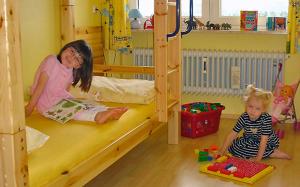 two children sitting on the floor in a room with bunk beds at Kappel App 21 in Lenzkirch