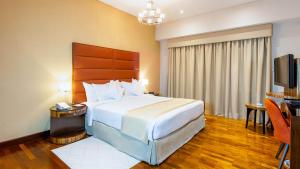 a hotel room with a bed and a television at City Premiere Hotel Apartments - Dubai in Dubai