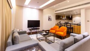 a living room with a couch and a tv at City Premiere Hotel Apartments - Dubai in Dubai