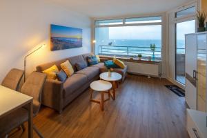 a living room with a couch and a table at Strandhotel Seeblick 66 in Dahme