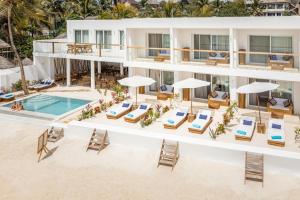 an aerial view of a hotel with chairs and a swimming pool at Imara Beach Resort in Kiwengwa