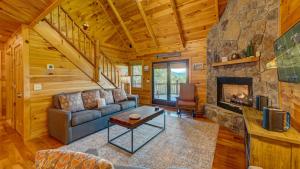 a living room with a couch and a fireplace at Bear Hug in Morganton