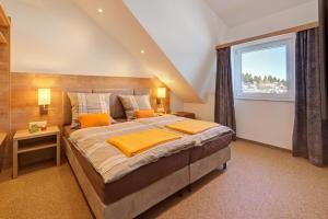 a bedroom with a large bed and a window at Forest 306 in Feldberg