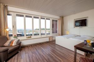 a hotel room with a bed and a large window at ancora Marina Haus 2 Nr 07, Typ 2 in Neustadt in Holstein