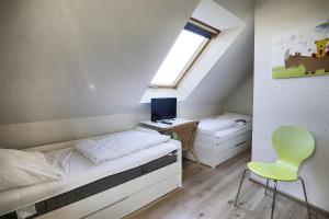 a bedroom with a bed and a desk and a window at Am Deich 14 in Zingst