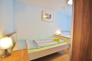 a small bedroom with a bed and a lamp at Koch 1 in Dahme