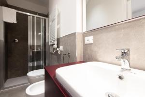 a bathroom with a white sink and a toilet at Goito 3, Bologna by Short Holidays in Bologna +2 photos