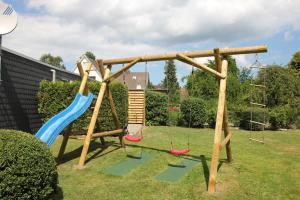 a swing set in a garden with two swings at Koch 1 in Dahme