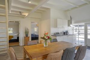 a kitchen and dining room with a wooden table and chairs at Daaldersplek Bantega in Bantega
