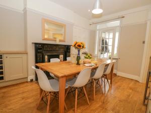 a dining room with a wooden table and chairs at Gillercombe in Bowness-on-Windermere