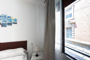 a bedroom with a bed and a large window at Marsala, Bologna by Short Holidays in Bologna