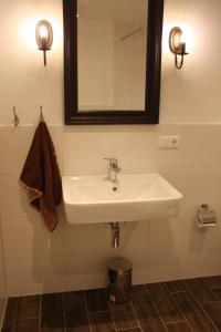 a bathroom with a white sink and a mirror at Feldlerche in Neue Tiefe Fehmarn