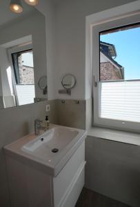 a bathroom with a sink and a large window at Skagen in Kronsgaard