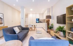 a living room with a couch and a table at Apartamentos Bellas Artes in San Sebastián