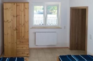 a bedroom with a dresser and a window at Ferienwohnung Brodda Kerntopp in Bisdorf