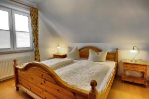 a bedroom with a wooden bed with two night stands at Ostseewelle Whg 3 in Zingst