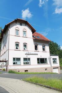 a large white building with a red roof at Hotel Restaurant Neu-Holland in Kassel