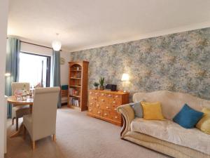 a living room with a couch and a table at 1 The Gardens in Stowmarket