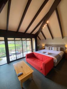 a bedroom with a large bed and a large window at Hahndorf Motel in Hahndorf