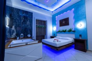 a bedroom with a bed and a tub and a sink at Pompei Luxury Rooms in Pompei +83 photos