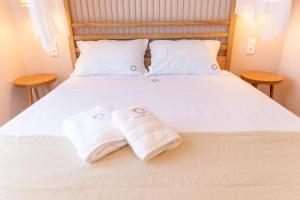 A bed or beds in a room at Two Olive Trees - Deluxe Apartments