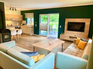 a living room with a couch and a table at Ferienhaus Hinz in Darlingerode