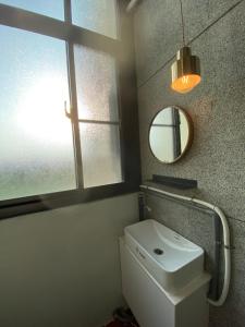 a bathroom with a white toilet and a mirror at House 平安 包棟民宿 寵物友善 in Anping