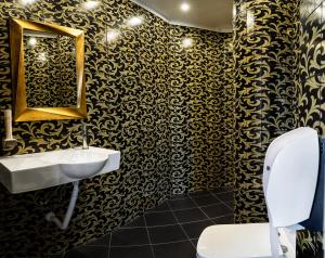 a bathroom with a sink and a mirror and a toilet at Hotel CITY Petrich in Petrich +42 photos