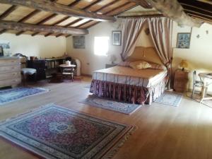 a bedroom with a bed in a room with rugs at Gerani Rossi in Bagnoregio