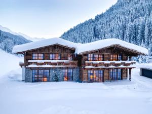 a log cabin with snow on the roof at Stadl Chalet Ischgl in Ischgl