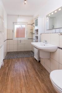 a bathroom with a sink and a toilet at Gästehaus Passat in Niendorf