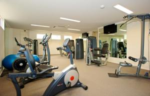 a gym with several treadmills and exercise bikes at Brooklands Of Mornington in Mornington