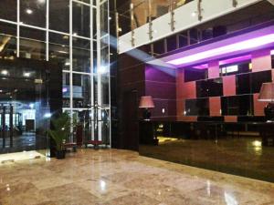 Serela Waringin by KAGUM Hotels في باندونغ: لوبي بطاولة وجدار زجاجي