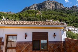 a house with a mountain in the background at La Casa de Esparto in Cazorla