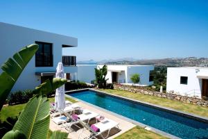 Blick auf eine Villa mit einem Pool in der Unterkunft Ramada Resort by Wyndham Bodrum in Bitez