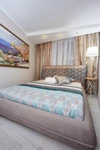 a bedroom with a large bed in a room at Langery Residence Central Apartments in Odesa