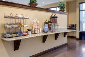 a lobby with a counter with food on it at Comfort Suites Jonesboro University Area in Jonesboro