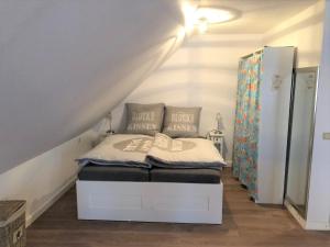 ein kleines Schlafzimmer mit einem Bett im Dachgeschoss in der Unterkunft Ferienwohnung Villa Wolke in Sankt Wendel