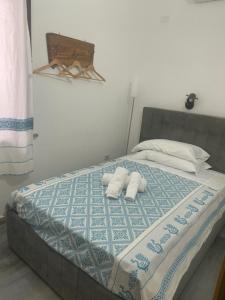 a white teddy bear sitting on top of a white bed at Il Giglio Affittacamere in Tortolì